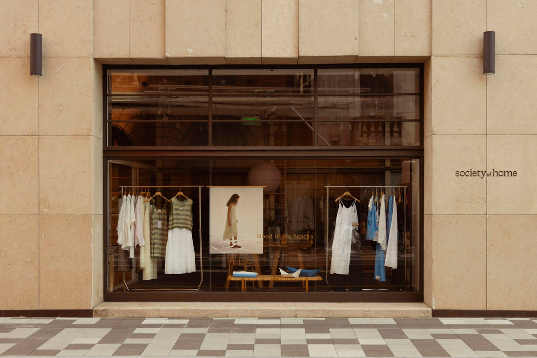 Clothing store window display with mannequins and racks