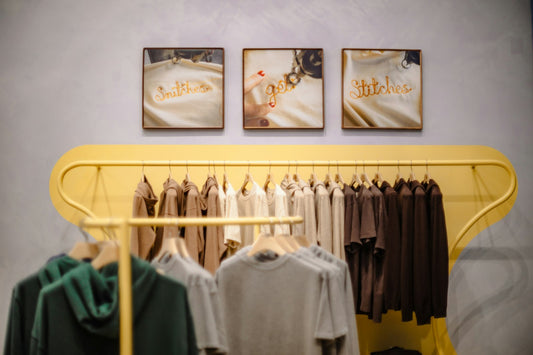 Clothing displayed on racks in a fashion retail store